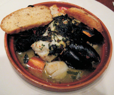 Scallops / Mussel Is bake with white wine with a herb bread crust in the shell